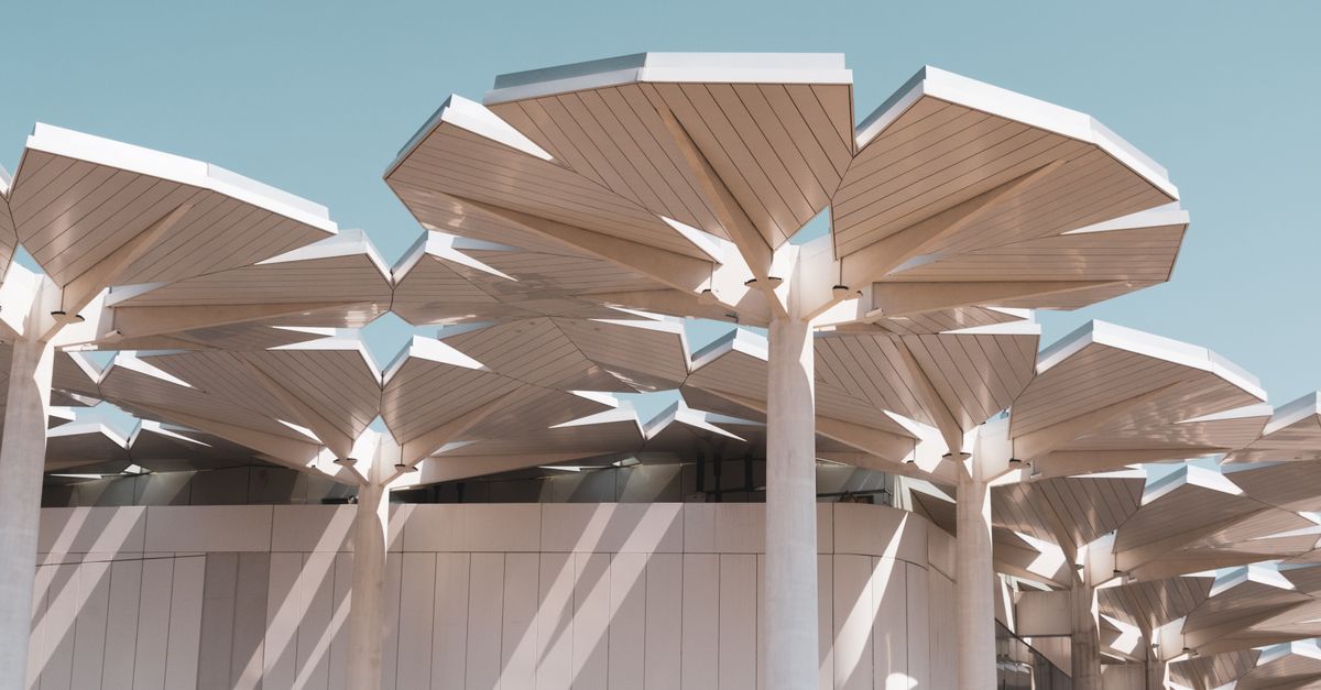 Contemporary architecture featuring innovative geometric rooftop structures in bright sunlight.